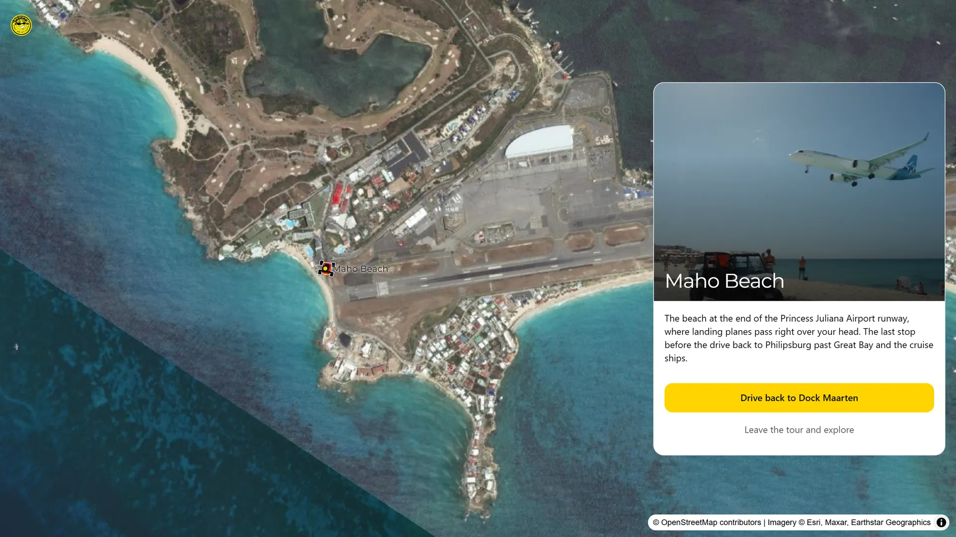 The planner open at the Maho Beach stop: satellite map of the Princess Juliana runway and coast, beside a card with a landing plane, the stop description and a button on to the next stop.